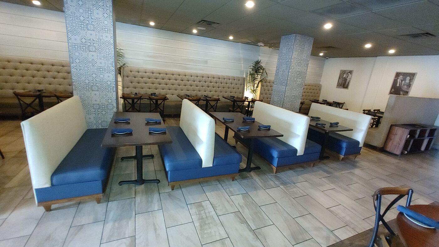 Custom upholstered banquette booth seating in a restaurant dining room